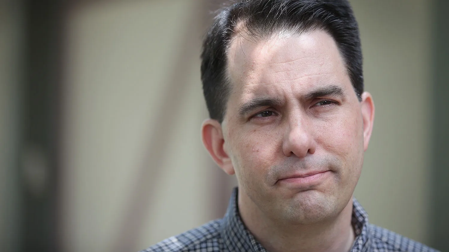 Governor Scott Walker of Wisconsin speaks to reporters outside Dallas County Recorder Chad Airhart's annual Blue Jean Bash on May 16, 2015 in West Des Moines, Iowa.
