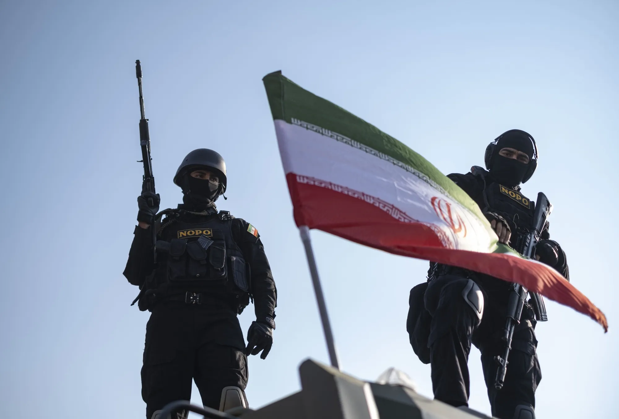 Two armed members of Iran's police special forces stand guard&nbsp;on an armored military vehicle&nbsp;in downtown Tehran,&nbsp;Jan.&nbsp;12, 2026.&nbsp;