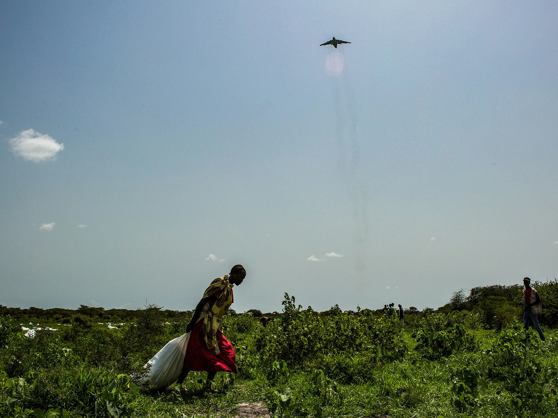 A woman drags&nbsp;a sack of maize and sorghum dropped from air by a World Food Programme plane in Jeich village, northern South Sudan,&nbsp;on July 3, 2018.&nbsp;