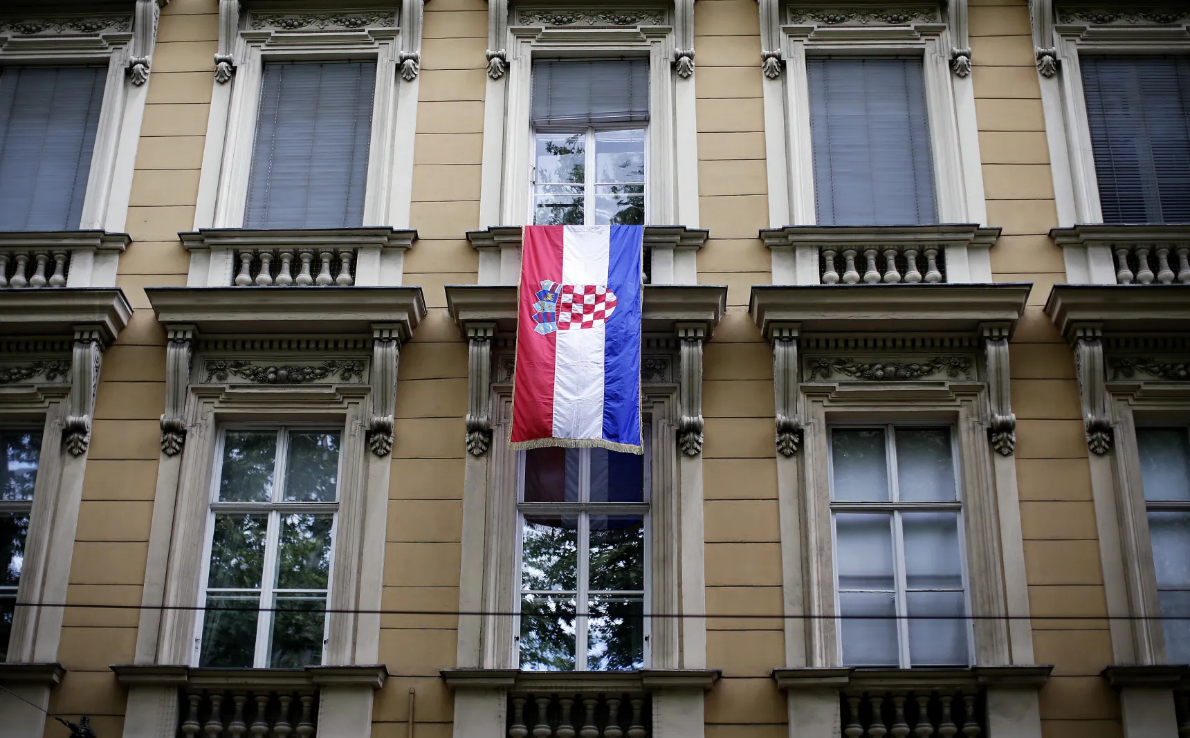 The Croatian national flag flies from building in central Zagreb, Croatia.