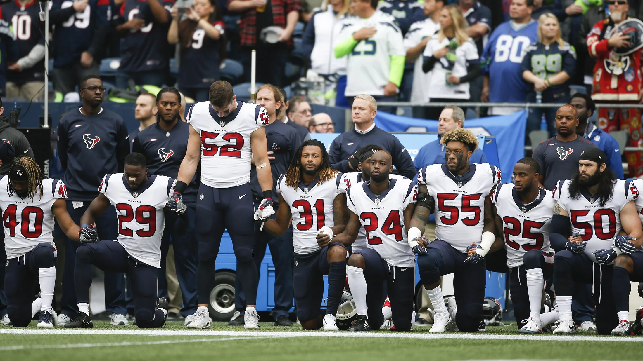 SEATTLE, WA - OCTOBER 29: Members of the Houston Texans stand and kneel before the game against the Seattle Seahawks at CenturyLink Field on October 29, 2017 in Seattle, Washington. During a meeting of NFL owners earlier in October, Houston Texans owner Bob McNair said 'we can't have the inmates running the prison', referring to player demonstrations during the national anthem.
