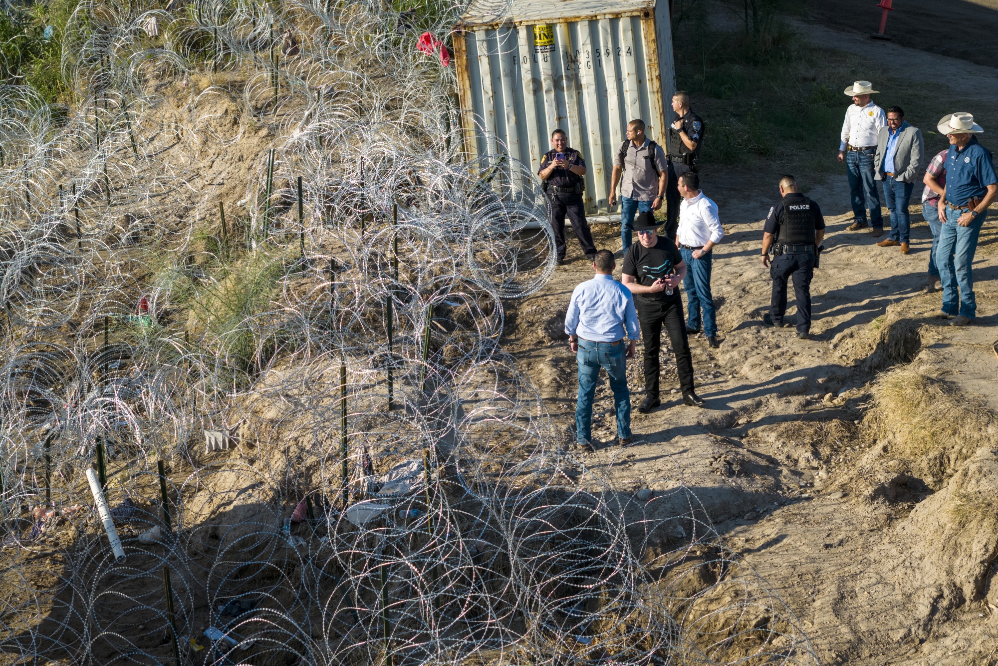 Elon Musk, wearing a black Stetson hat, visits the US-Mexico border in Eagle Pass in 2023.