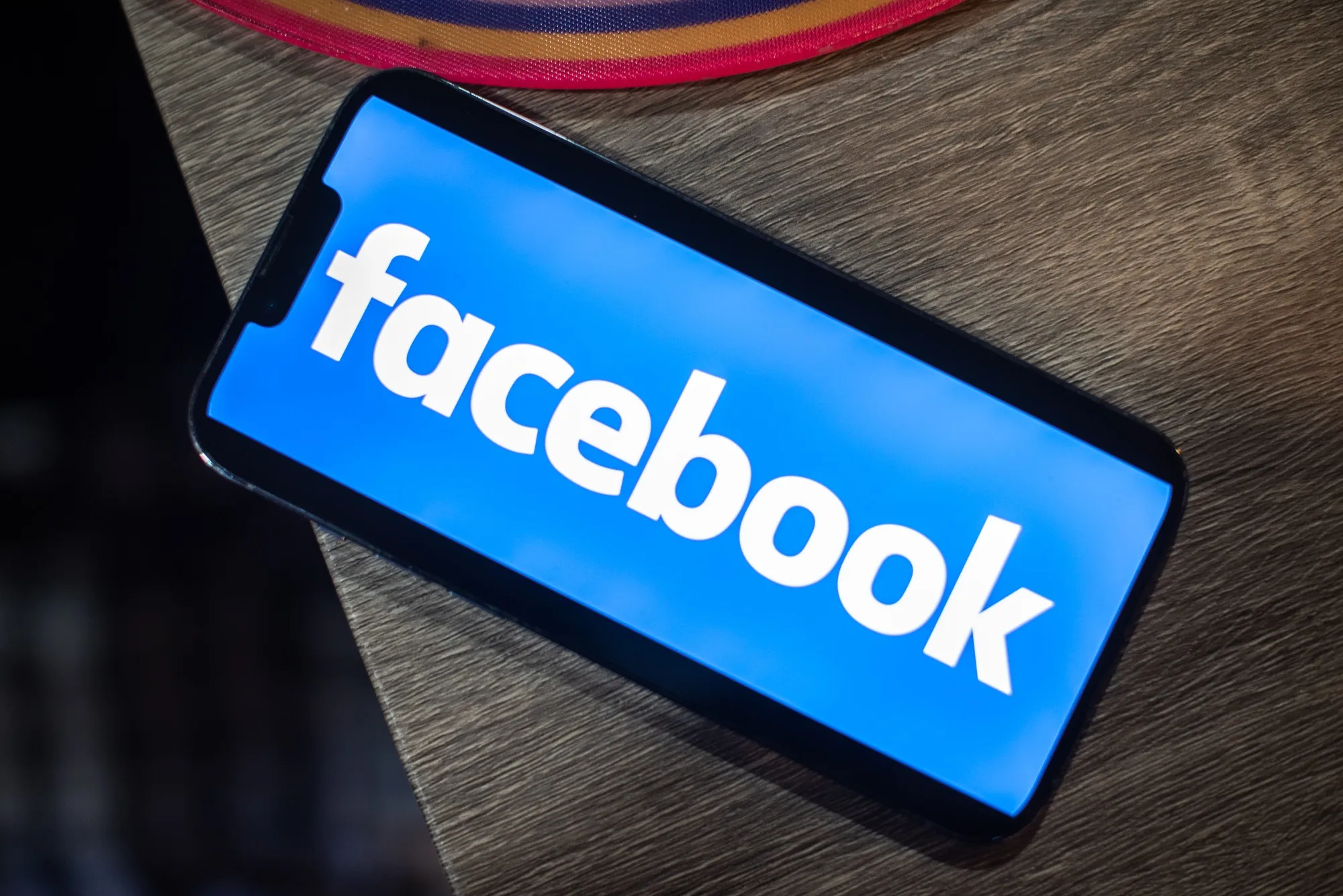 The Facebook logo on a smartphone.