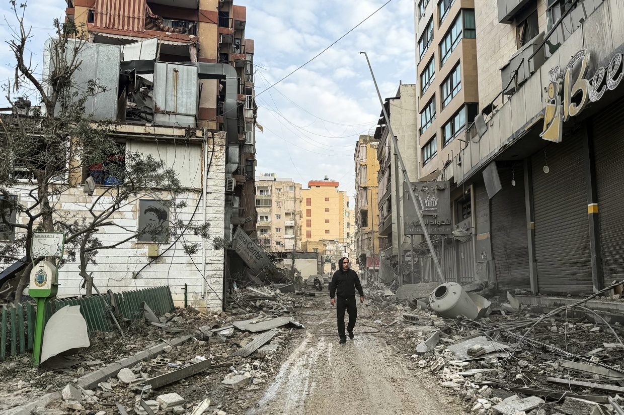 A man walks amid damaged buildings following overnight airstrikes in Beirut on March 12. Photographer: Ibrahim Amro/AFP/Getty Images
