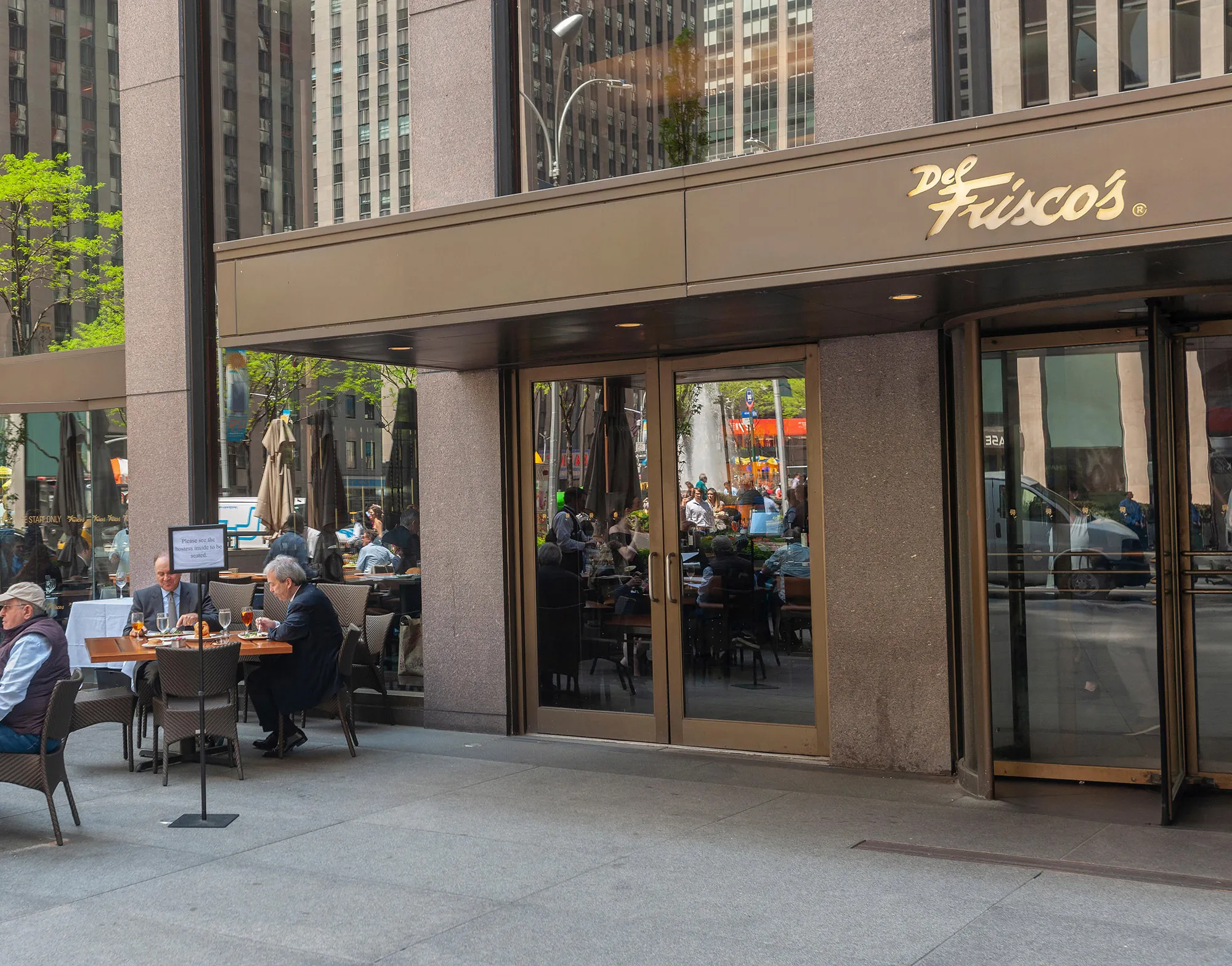 Diners sit outside Del Frisco’s Grille in Manhattan.