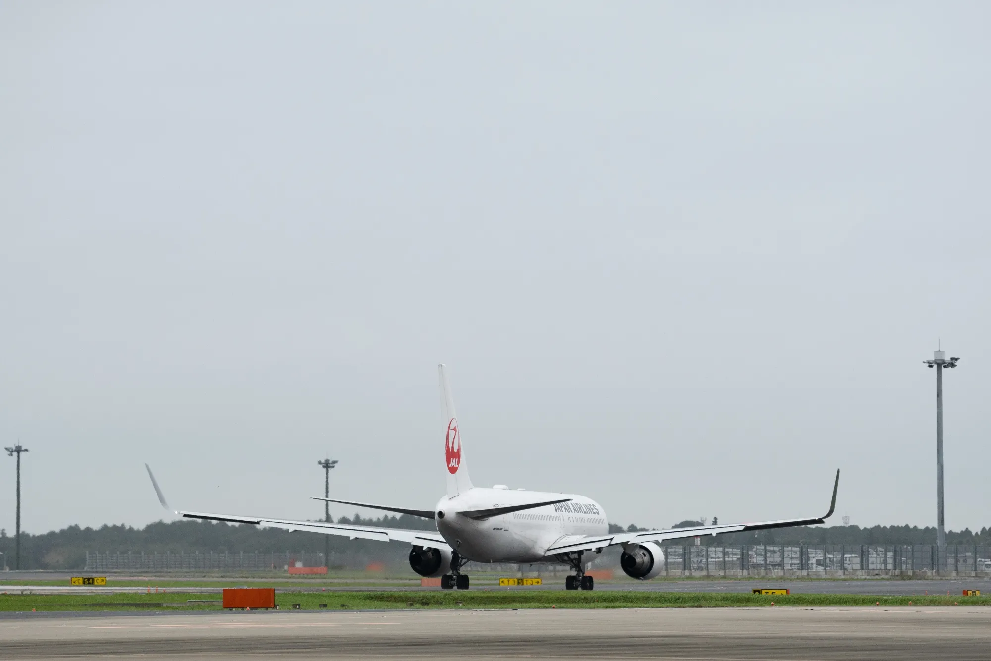 A Boeing 767-300ER passenger aircraft operated by JAL at Narita Airport in Japan.
