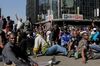Demonstrators sit and sing protest songs after police cordoned off the street on Aug. 16