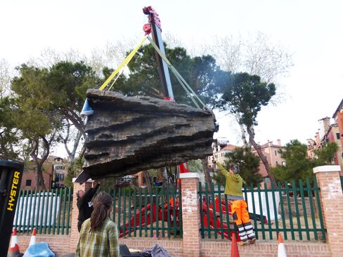 Next, a crane hoisted the pieces over the garden wall.
