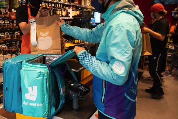 A Deliveroo courier collects a customer order in Paris.