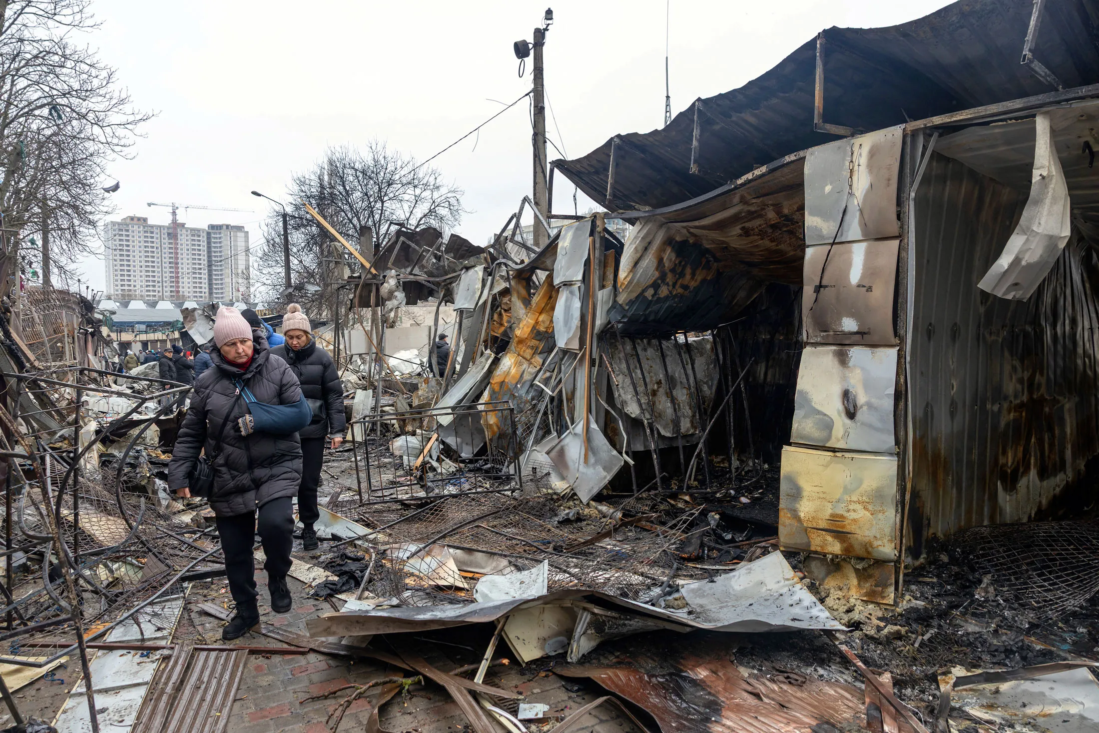 Residents walk through a market damaged following a Russian attack, in Odesa, Ukraine, on Feb. 12.