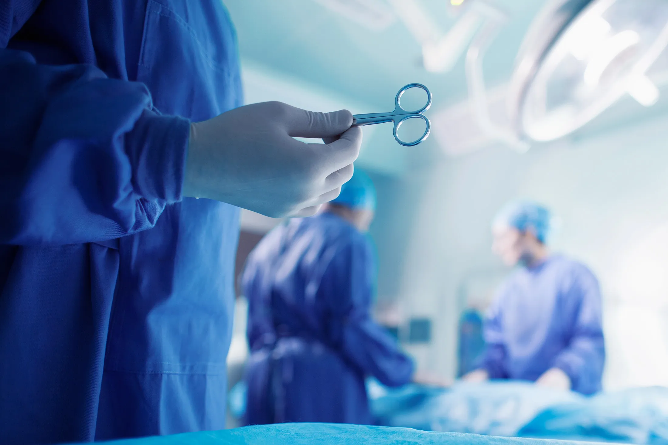 Doctors performing surgery in hospital operating room