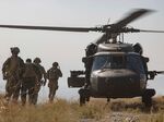 Afghan National Army soldiers and coalition advisers board a UH-60 Black Hawk helicopter in southern Afghanistan in 2019.