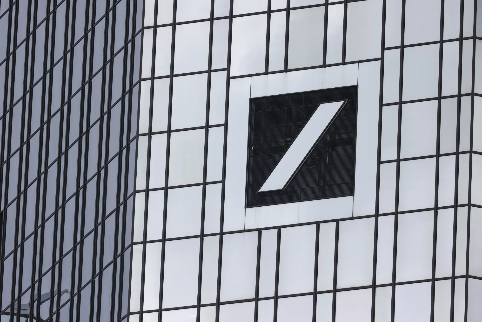 A logo on the exterior of the Deutsche Bank AG headquarters in the financial district of Frankfurt, Germany, on Thursday, Feb. 1, 2024. Deutsche Bank plans to cut 3,500 jobs over the coming years as Chief Executive Officer Christian Sewing seeks to make good on a pledge to lift profitability and return more money to shareholders.