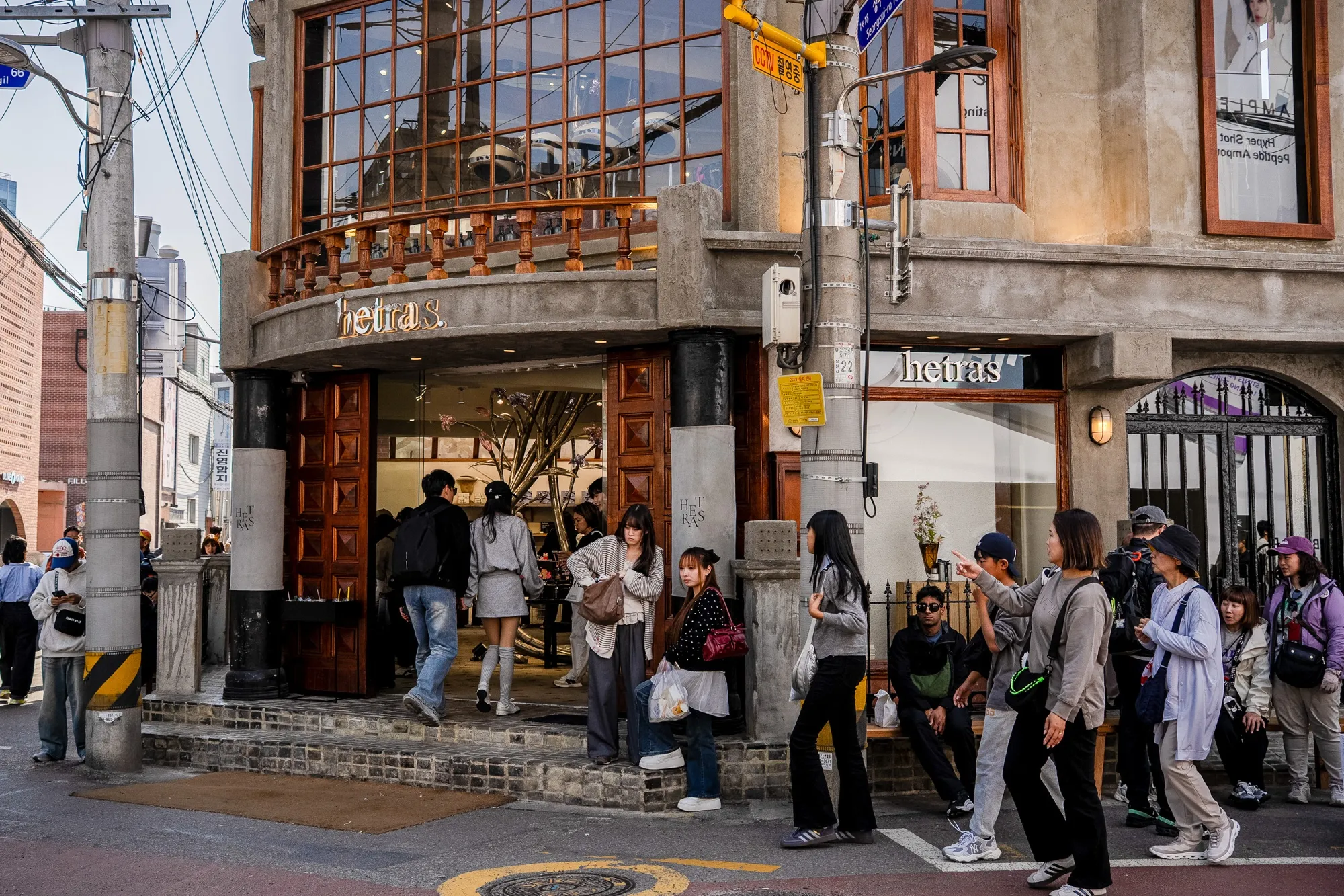 People walk past shops, cafes and converted warehouse buildings in Seongsu-dong, Seoul, South Korea.