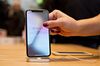 An employee picks up an Apple Inc. iPhone X.