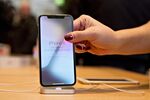 An employee picks up an Apple Inc. iPhone X.