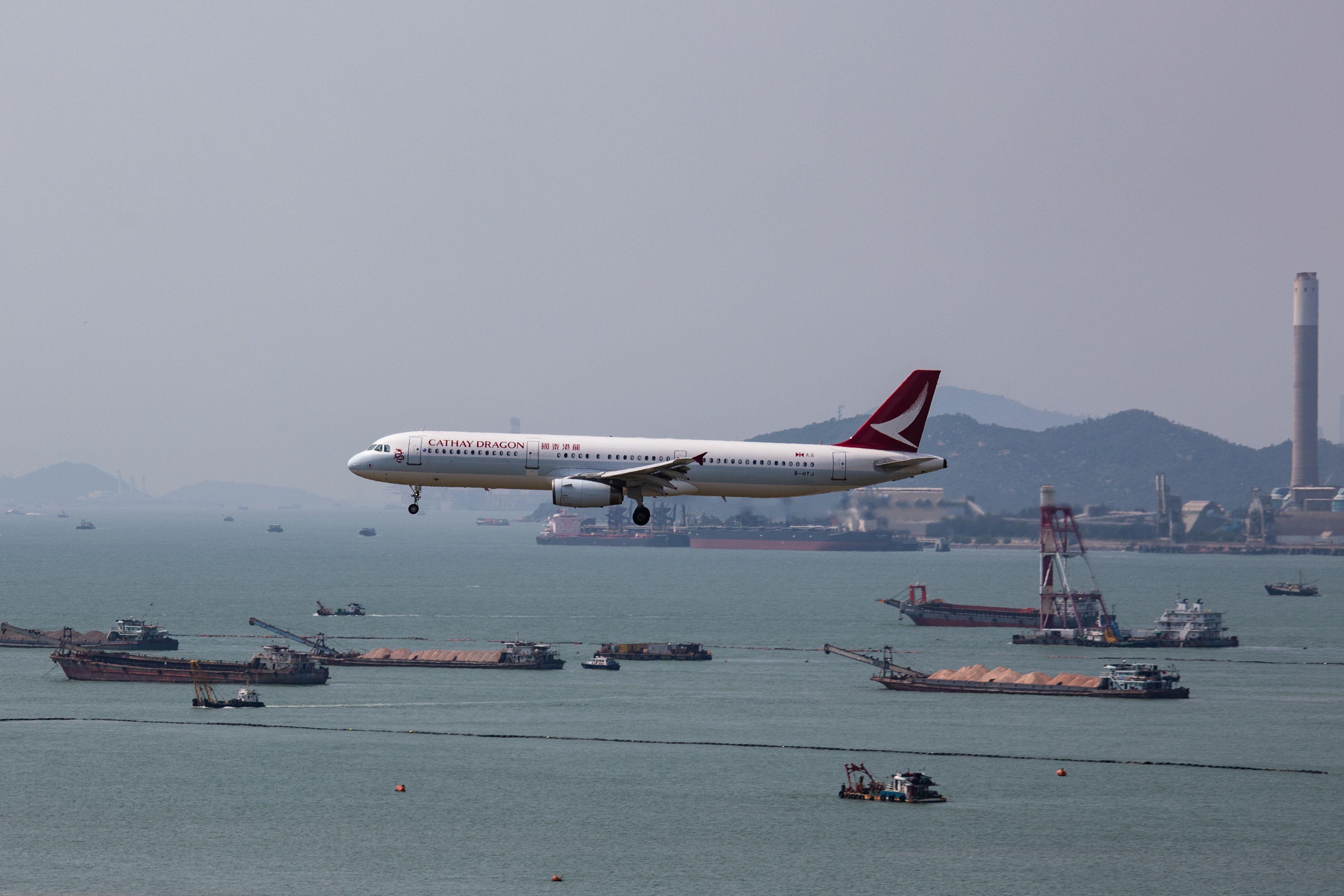 A Cathay Dragon passenger jet comes into land during a protest at Hong Kong International Airport.