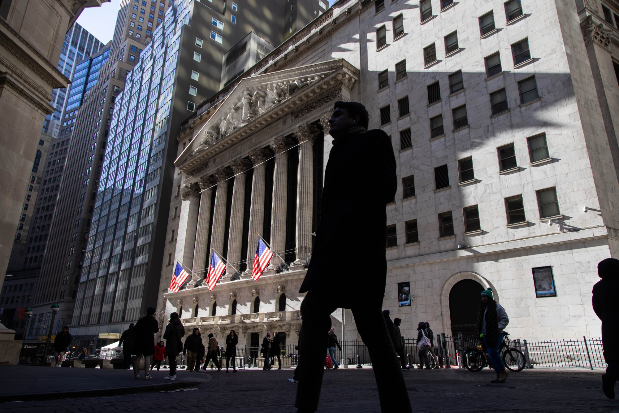Pedestrians outside of the New York Stock Exchange (NYSE) in New York, US, on Tuesday, Jan. 28, 2025. Ever since the global financial crisis, in an attempt to align pay to shareholder returns, banks have relied more heavily on restricted stock units when they’re handing out bonuses.