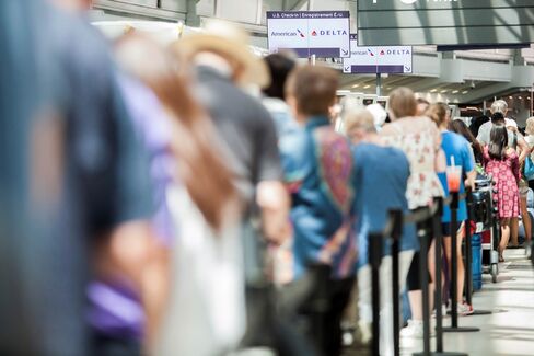 Passengers await updates from Delta at Pearson International Airport in Toronto, on Aug. 8.