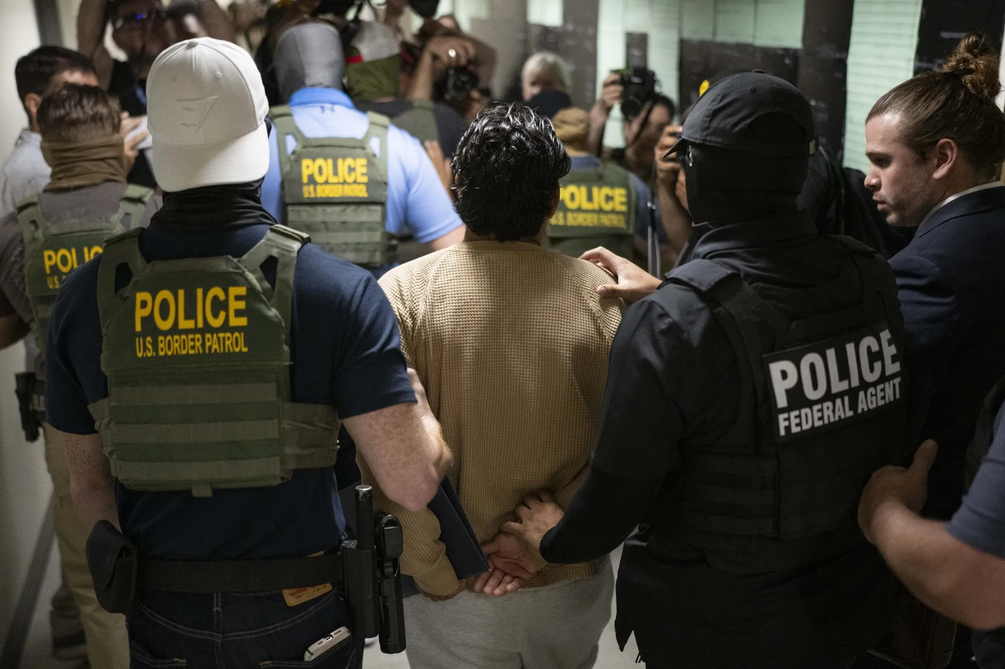 Federal agents detain a person following an immigration&nbsp;hearing&nbsp;in New York.