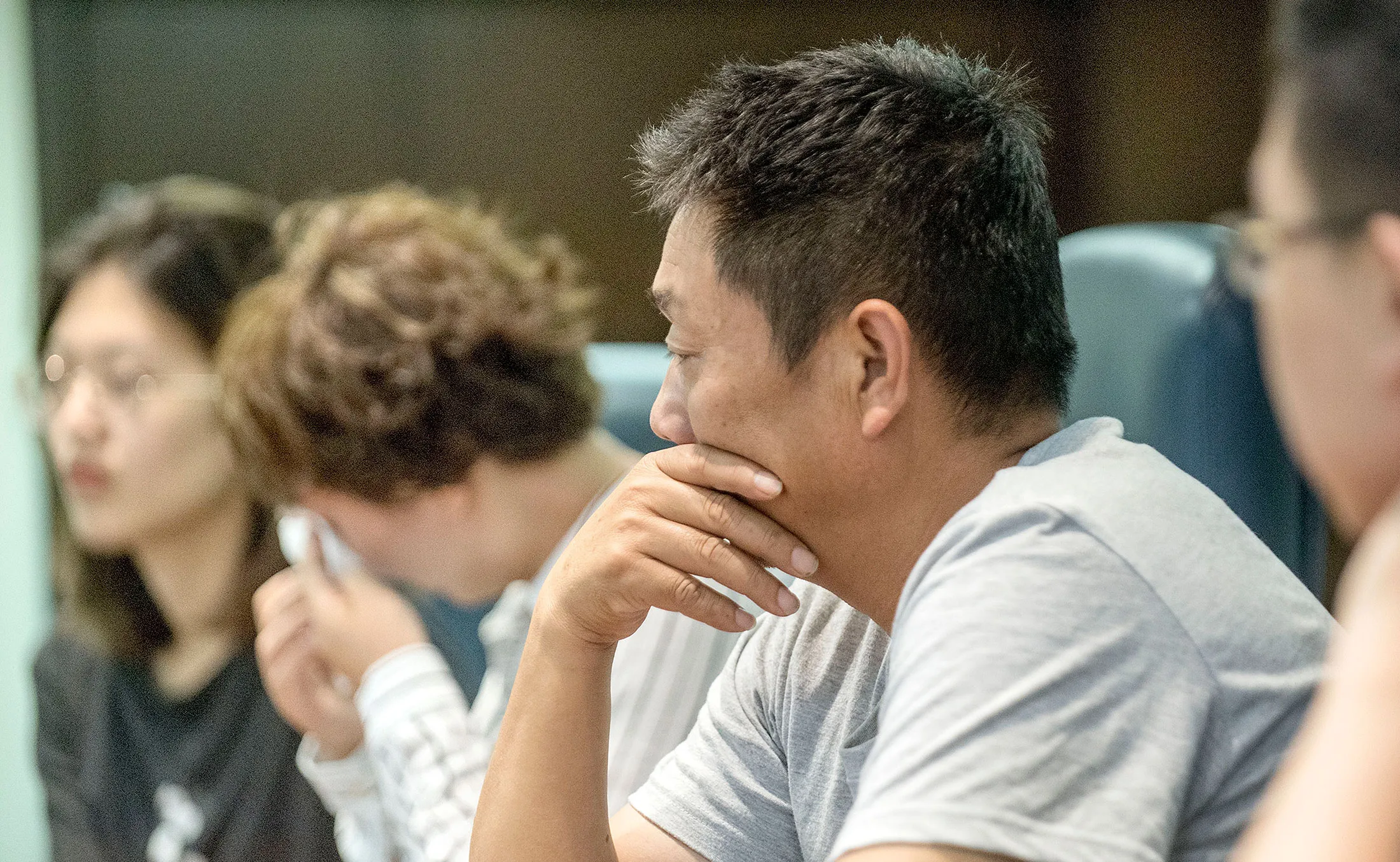 Ronggao Zhang, center, father of missing University of Illinois scholar Yingying Zhang, listens as he joins, from left, Yingying's best friend, Yige Yang, aunt Liqin Ye, and boyfriend, Xiaolin Hou, far right, for an interview at The Champaign, June 22.News-Gazette in Champaign, Ill, June 22.
