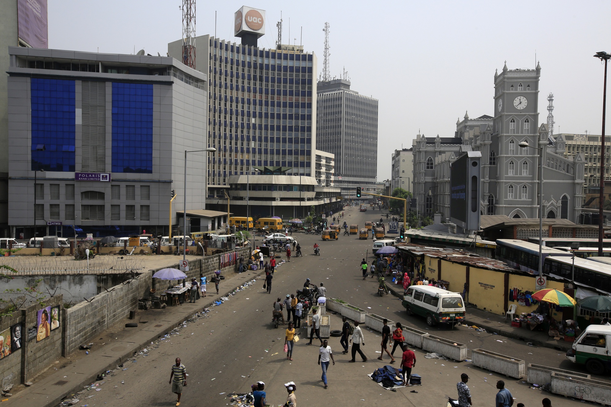 Pedestrians walk on a street in the business district in Lagos, Nigeria.