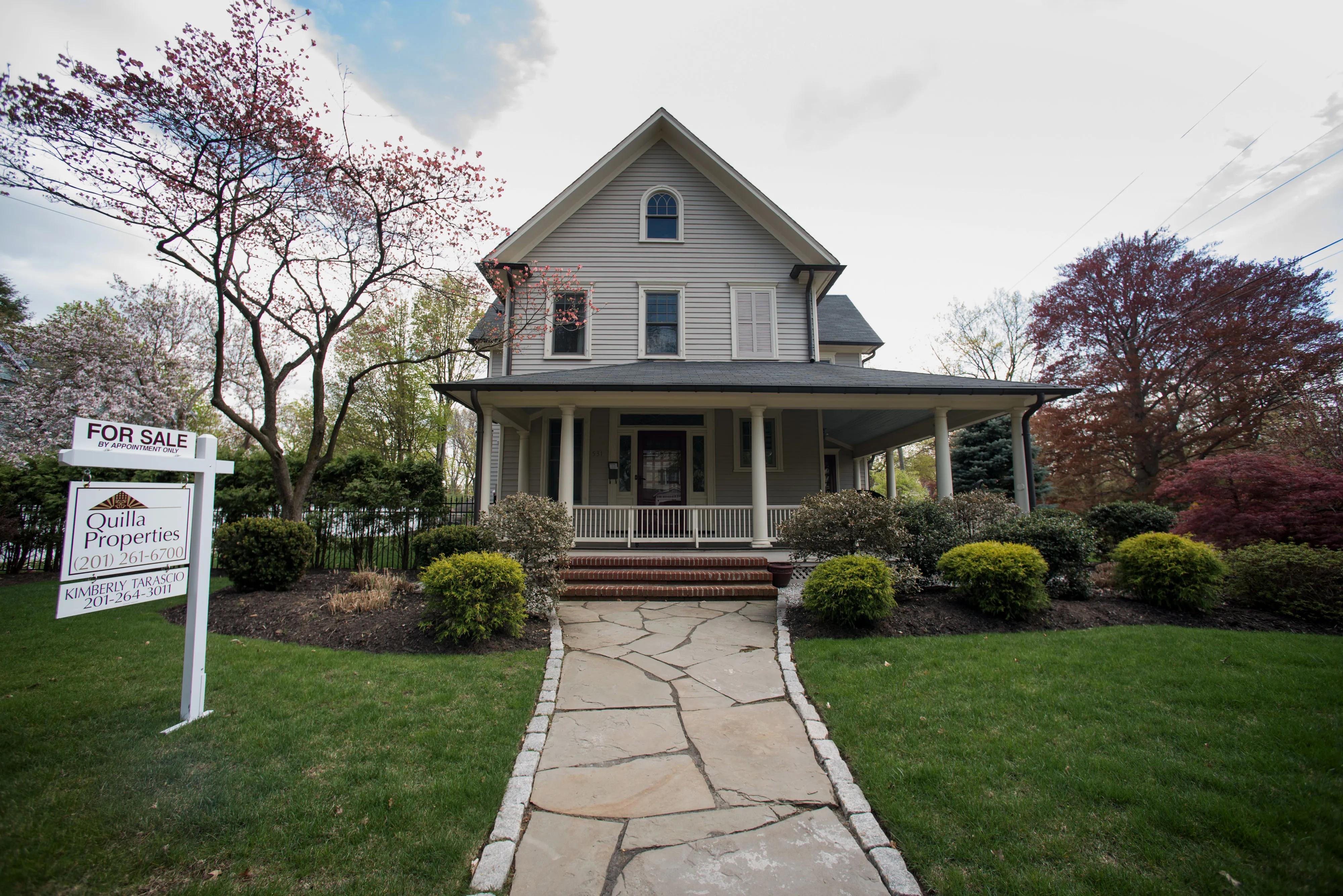 A "For Sale" sign is displayed outside of a house in Oradell, New Jersey, U.S..
