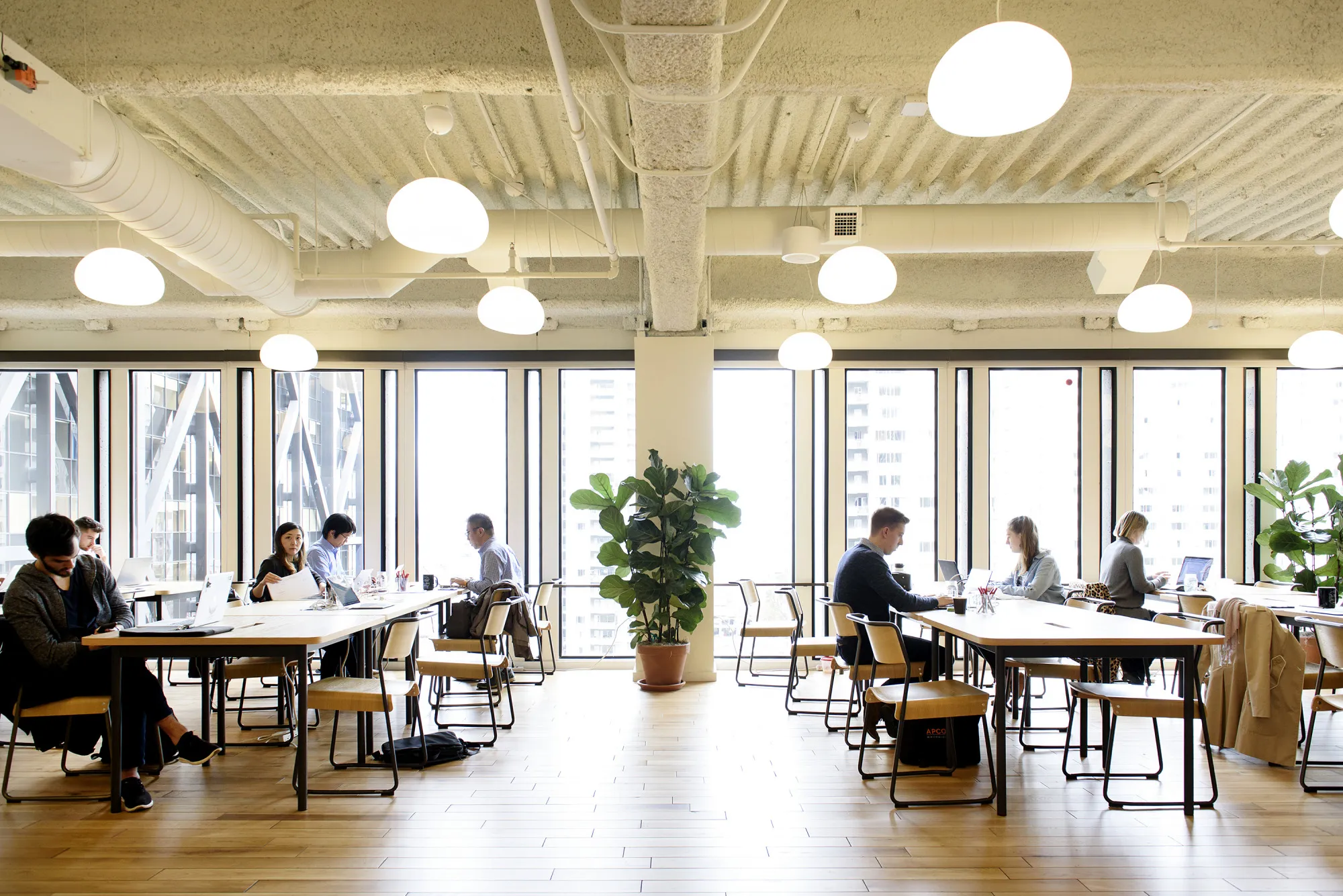 Members work on laptop computers in a common room at the Embarcadero WeWork Cos Inc. offices in San Francisco, California, U.S., on Thursday, Oct. 19, 2017. WeWork has focused its attention on Asia since 2016 with the opening of its first facility in Shanghai amid booming demand for flexible work spaces.