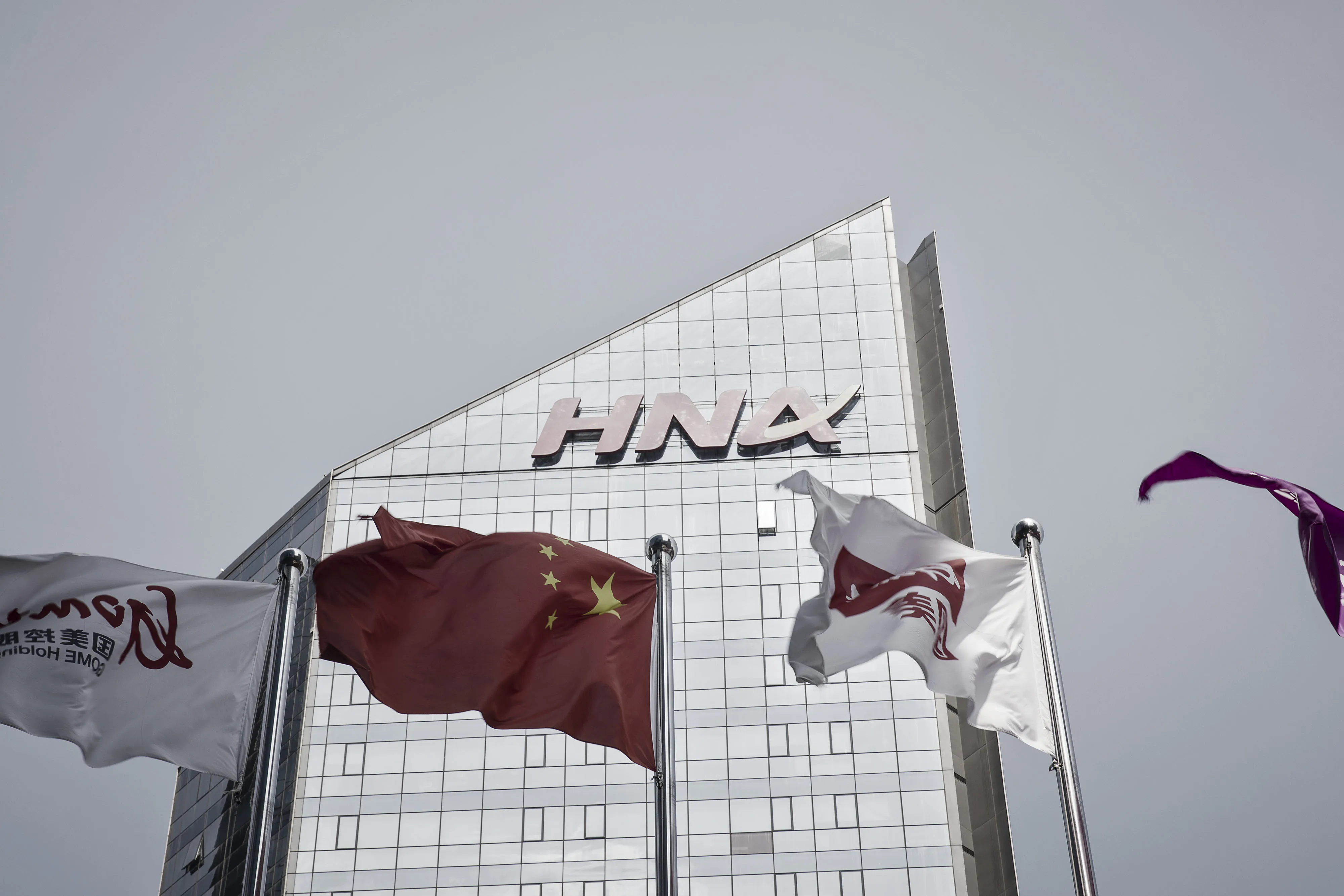 The HNA Group Co. building stands in Beijing, China, on Wednesday, Aug. 9, 2017. Big Chinese dealmakers including HNA have been under increasing scrutiny this year as the Communist Party steps up its clampdown of capital outflows to protect the yuan from weakening further.