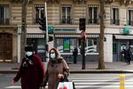 Pedestrians in protective face masks pass a BNP Paribas SA bank branch in Paris, France, on Tuesday, Nov. 3, 2020.