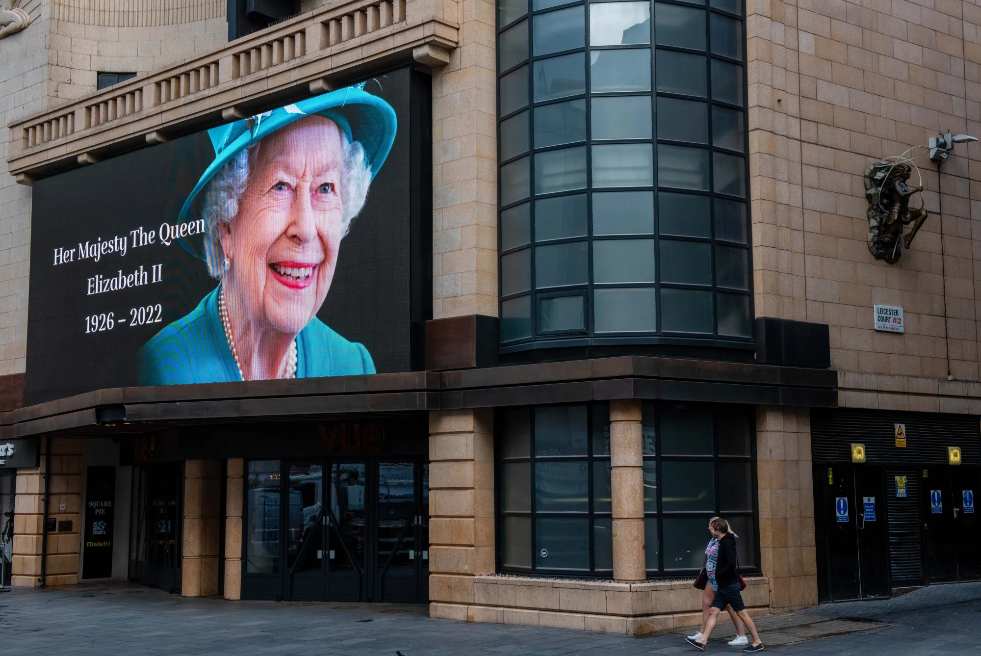 A billboard displays a tribute to Queen Elizabeth II.