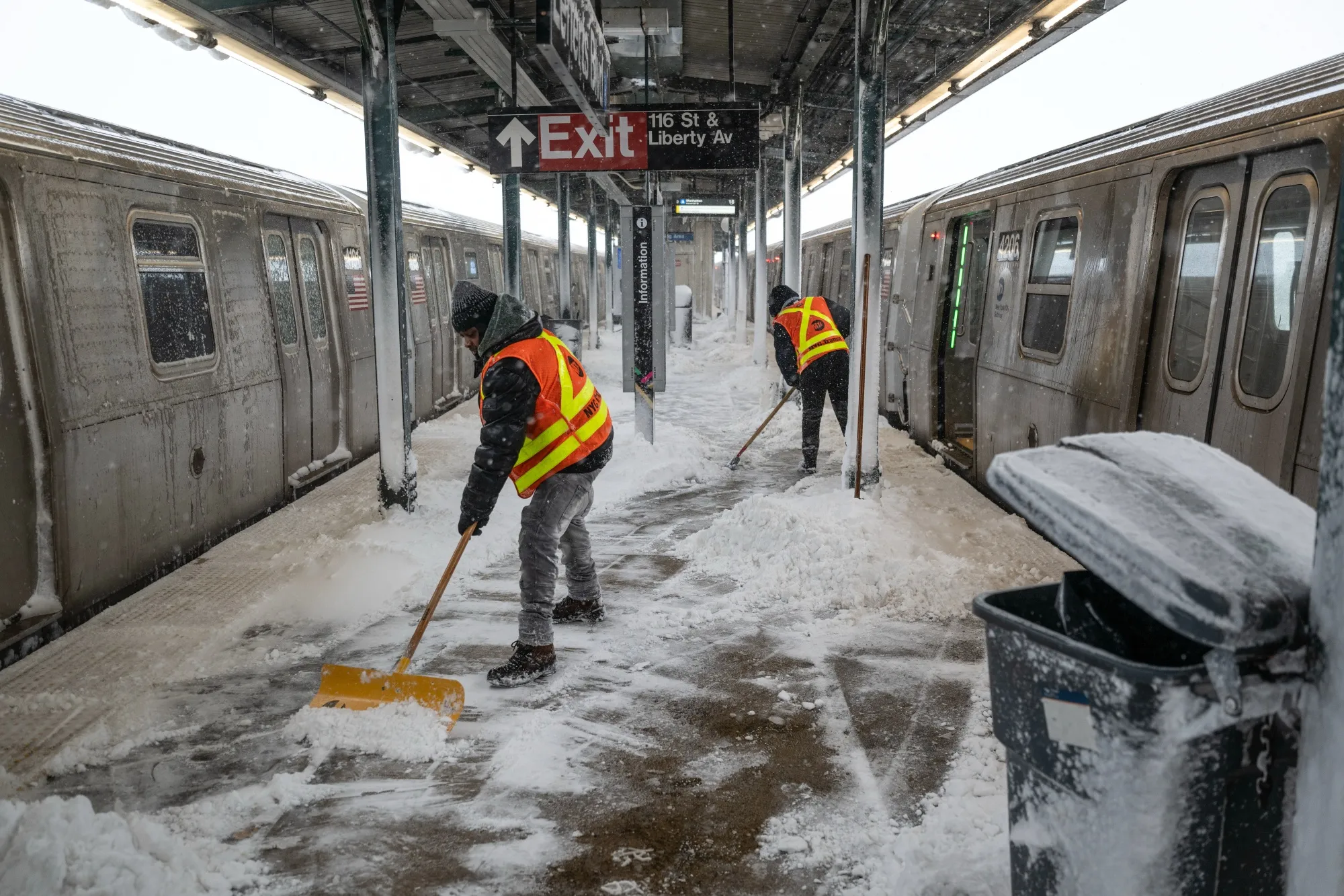 MTA workers clear snow from a subway station platform in the Queens borough of New York on Feb. 23. 