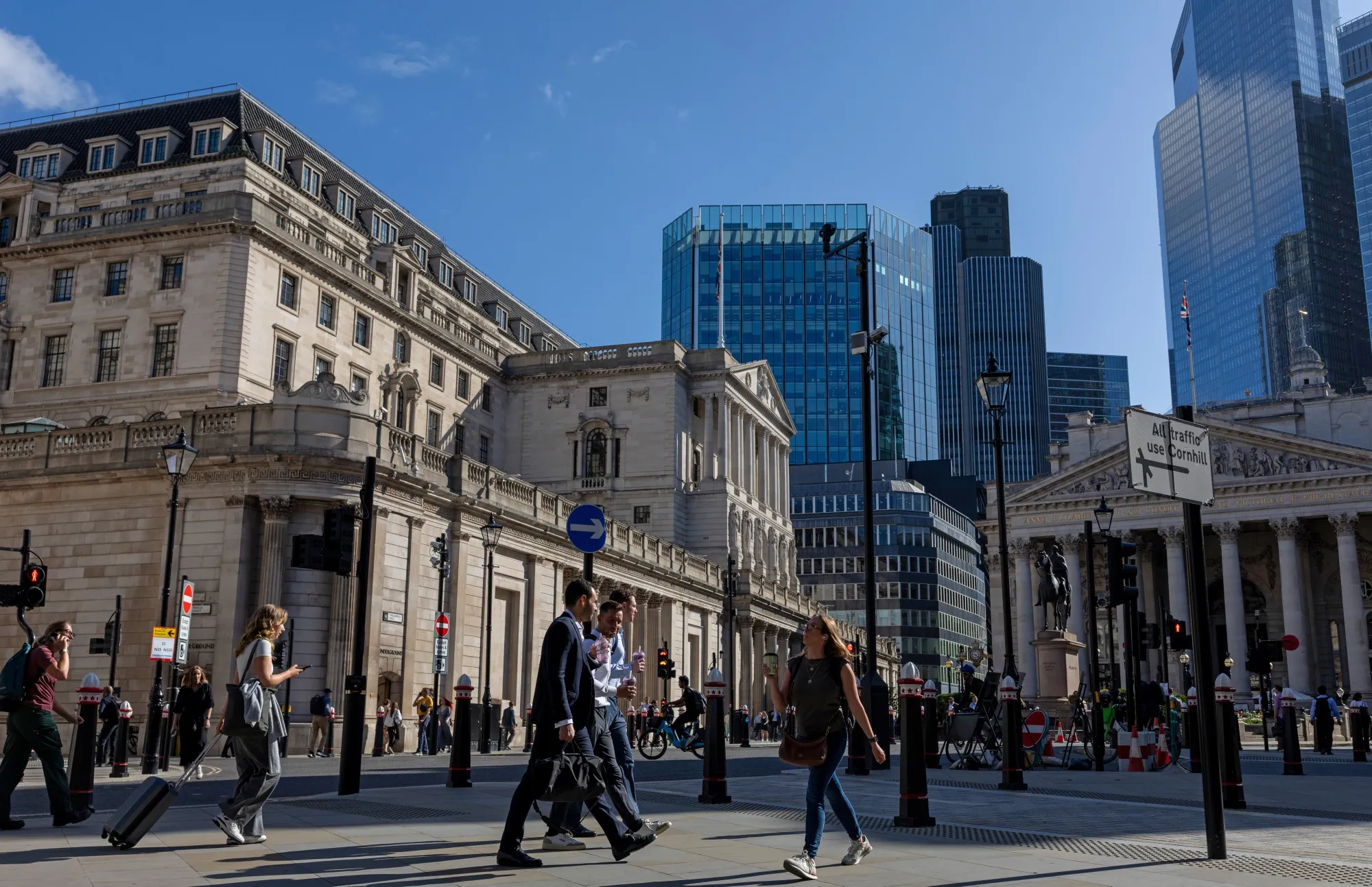 Workers outside the headquarters of the Bank of England in London.