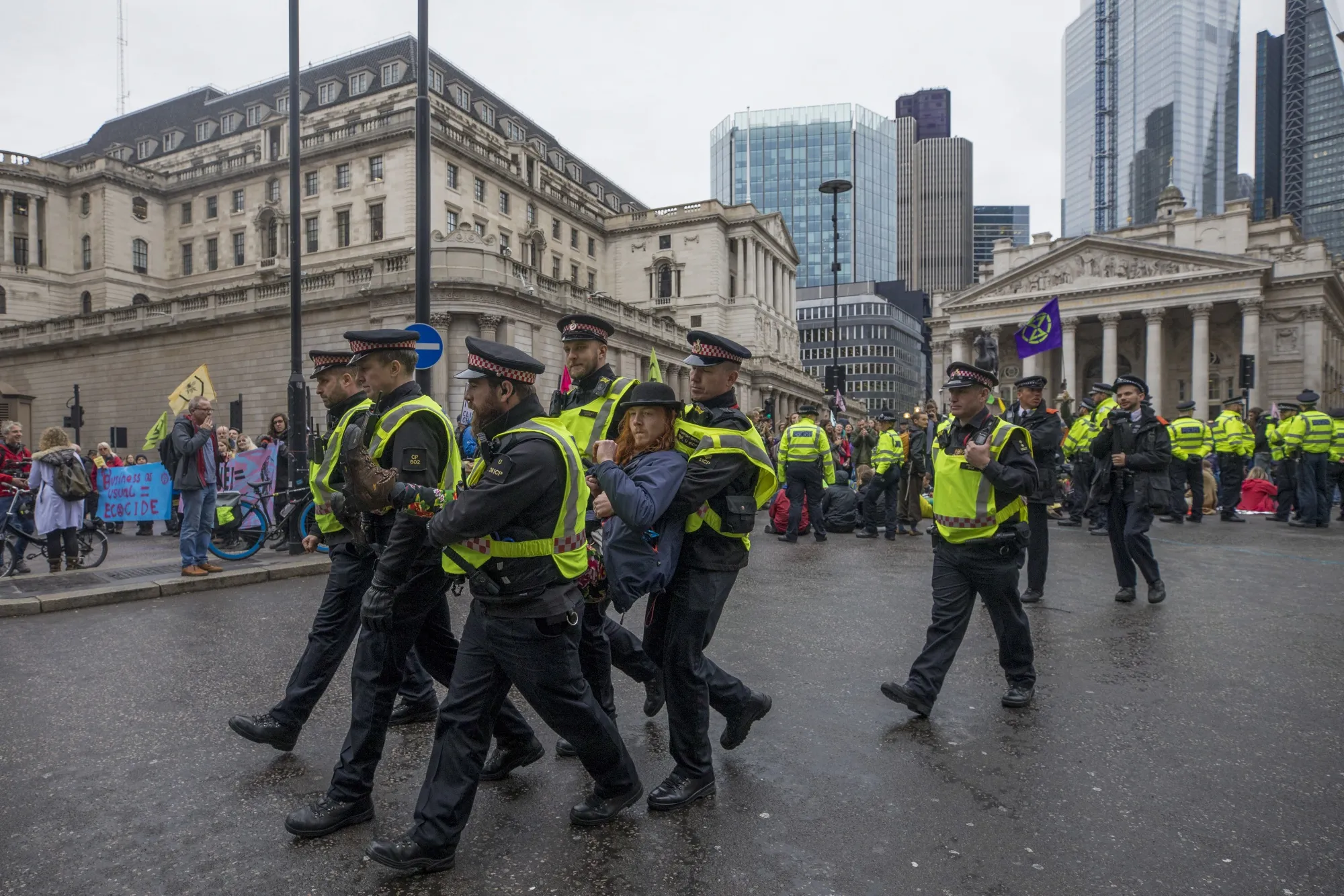 Police officers detain an activist from the climate protest movement Extinction Rebellion, Oct. 14.
