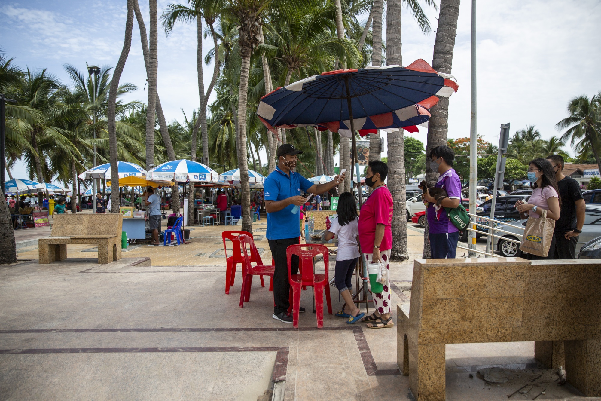 Visitors have their&nbsp;temperature checked at an entrance to a beach in Chonburi, Thailand, on&nbsp;June 14.&nbsp;