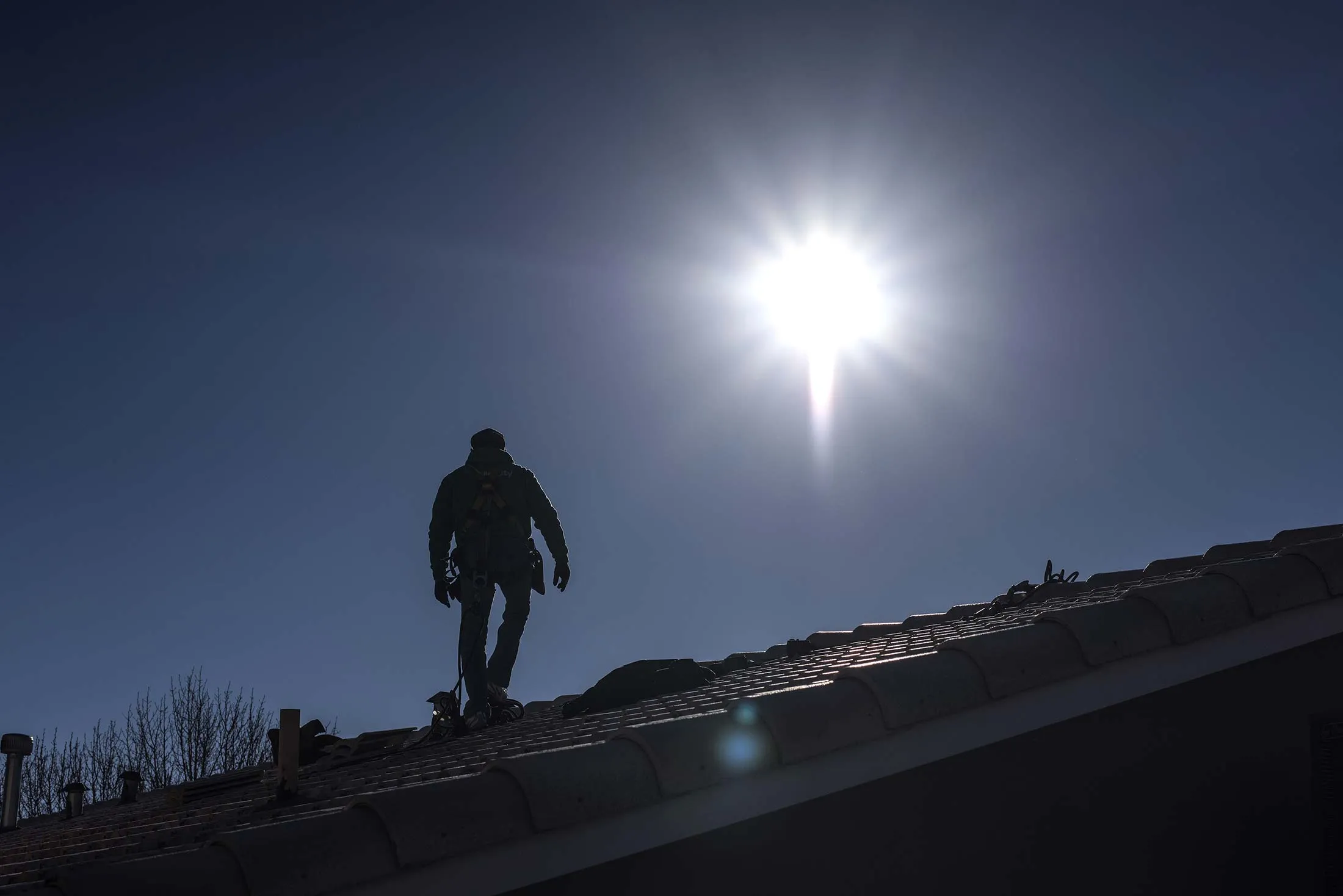 The silhouette of a worker is seen walking on a roof during a SolarCity Corp. residential installation in Albuquerque, New Mexico, U.S., on Monday, Feb. 8, 2016. SolarCity is scheduled to release earnings figures on February 9.
