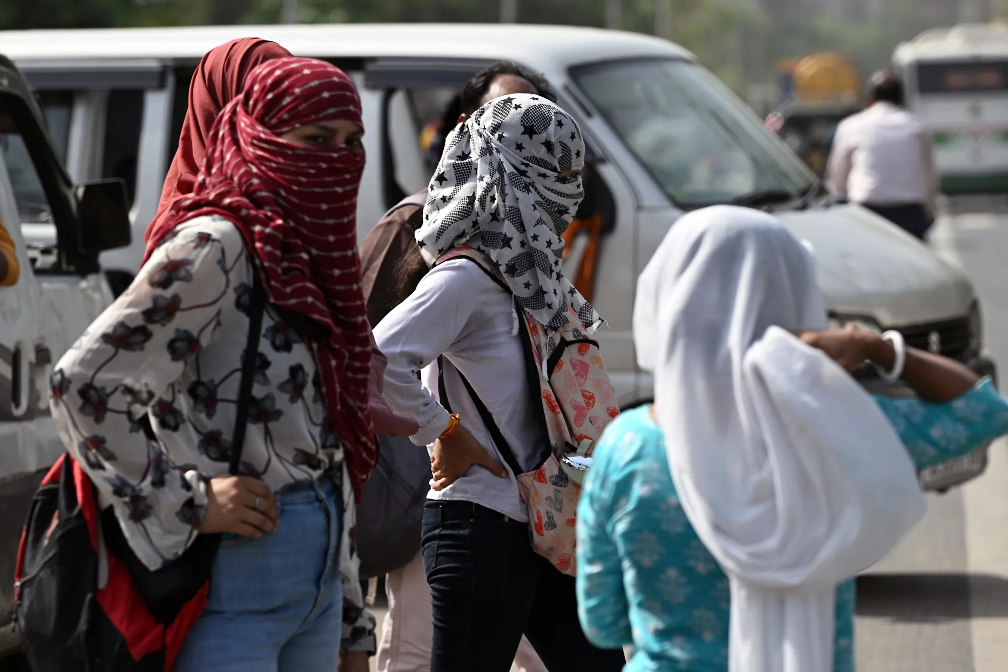 Pedestrians cover their faces to shield from the sun during high temperatures in New Delhi, India, on Thursday, May 30, 2024. Temperatures at a weather observatory in India’s capital city touched 52.9C (127F) on Wednesday, evidence of a worsening heat wave that also sent peak electricity demand in Delhi to an all-time high.