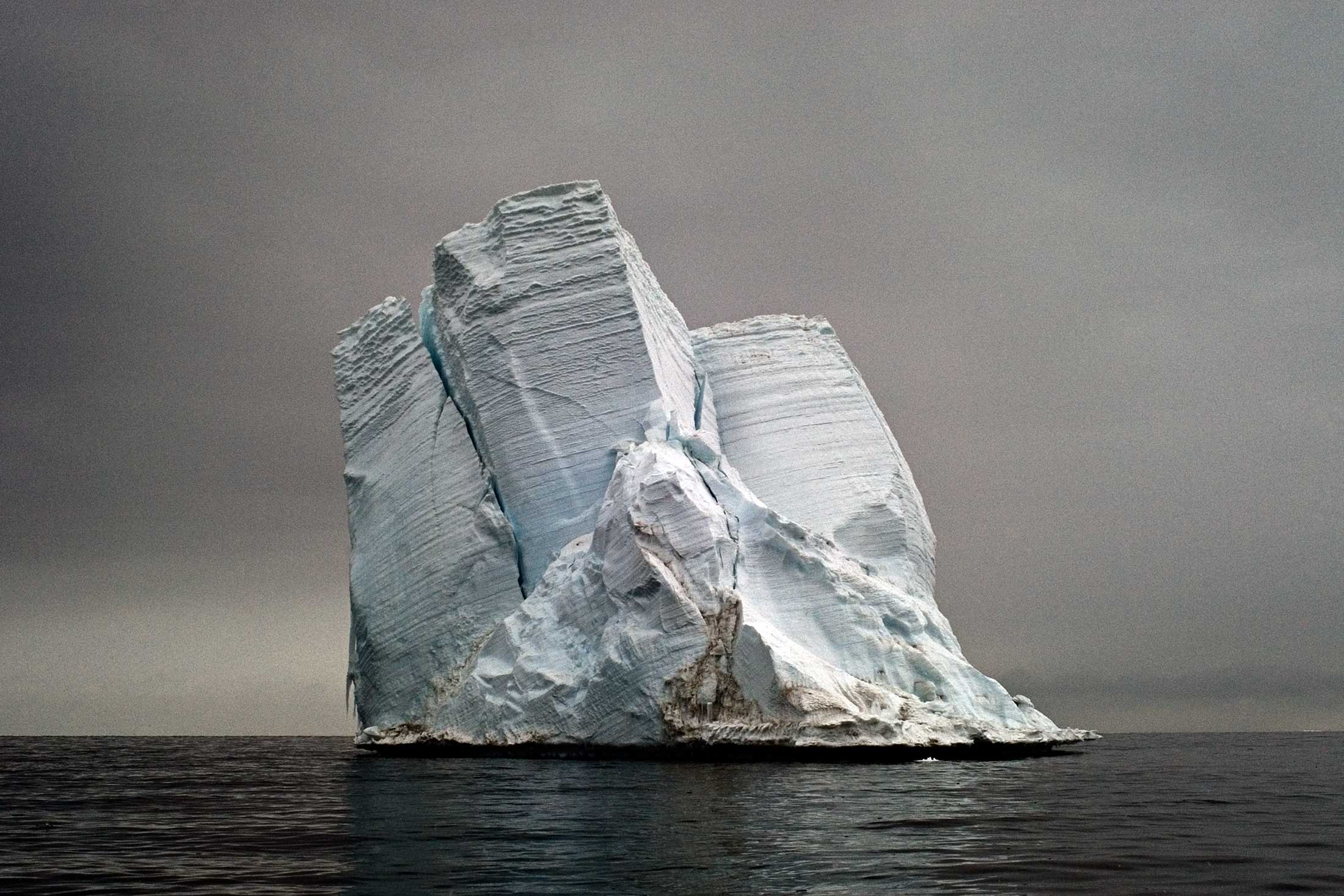 Glassy blue iceberg goes belly up