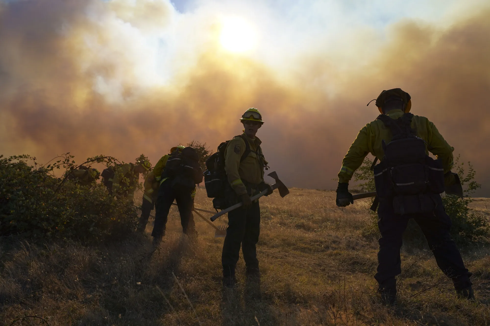 Firefighters work to remove flammable materials during the Zogg Fire near the town of Igo in Shasta County, California on Sept. 27.