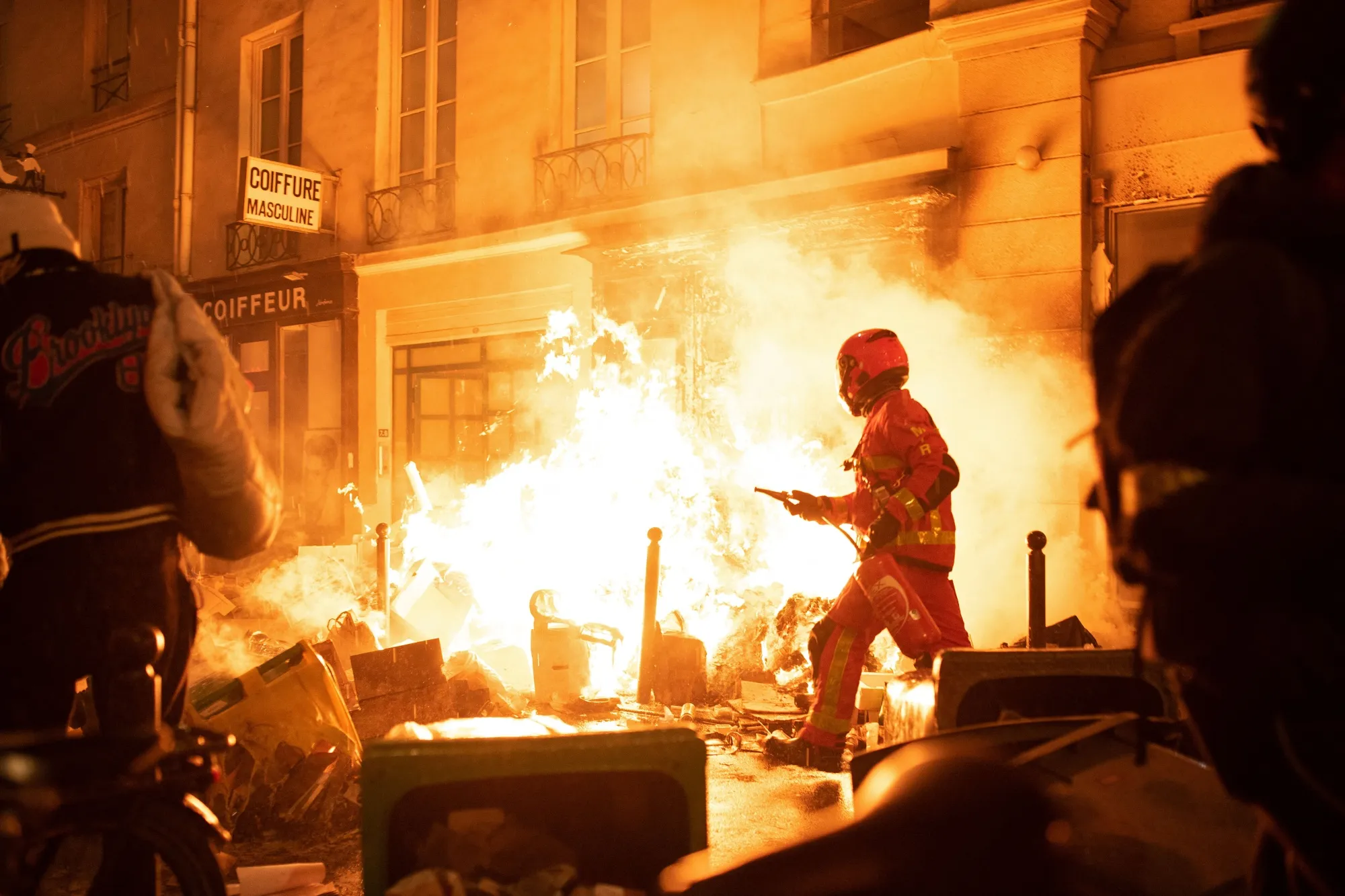 A firefighter tries to extinguish a fire during a demonstration&nbsp;in Paris on March 23.