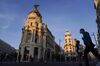 Pedestrians wearing protective face masks cross the street along the Gran Via in Madrid, Spain, on Thursday, Oct. 8, 2020. 