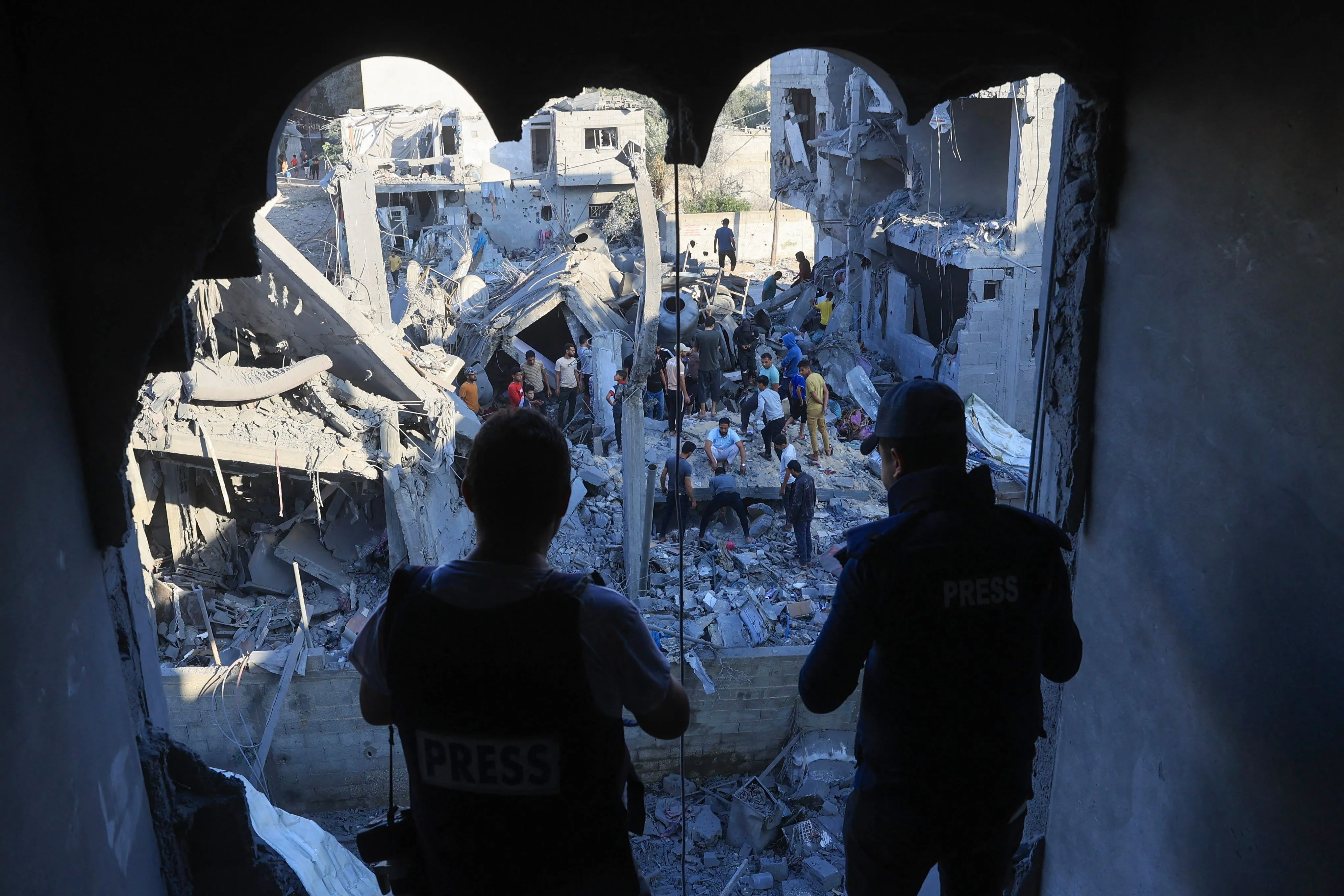 Palestinians inspect destroyed buildings in Rafah, southern Gaza Strip, on Oct. 18.