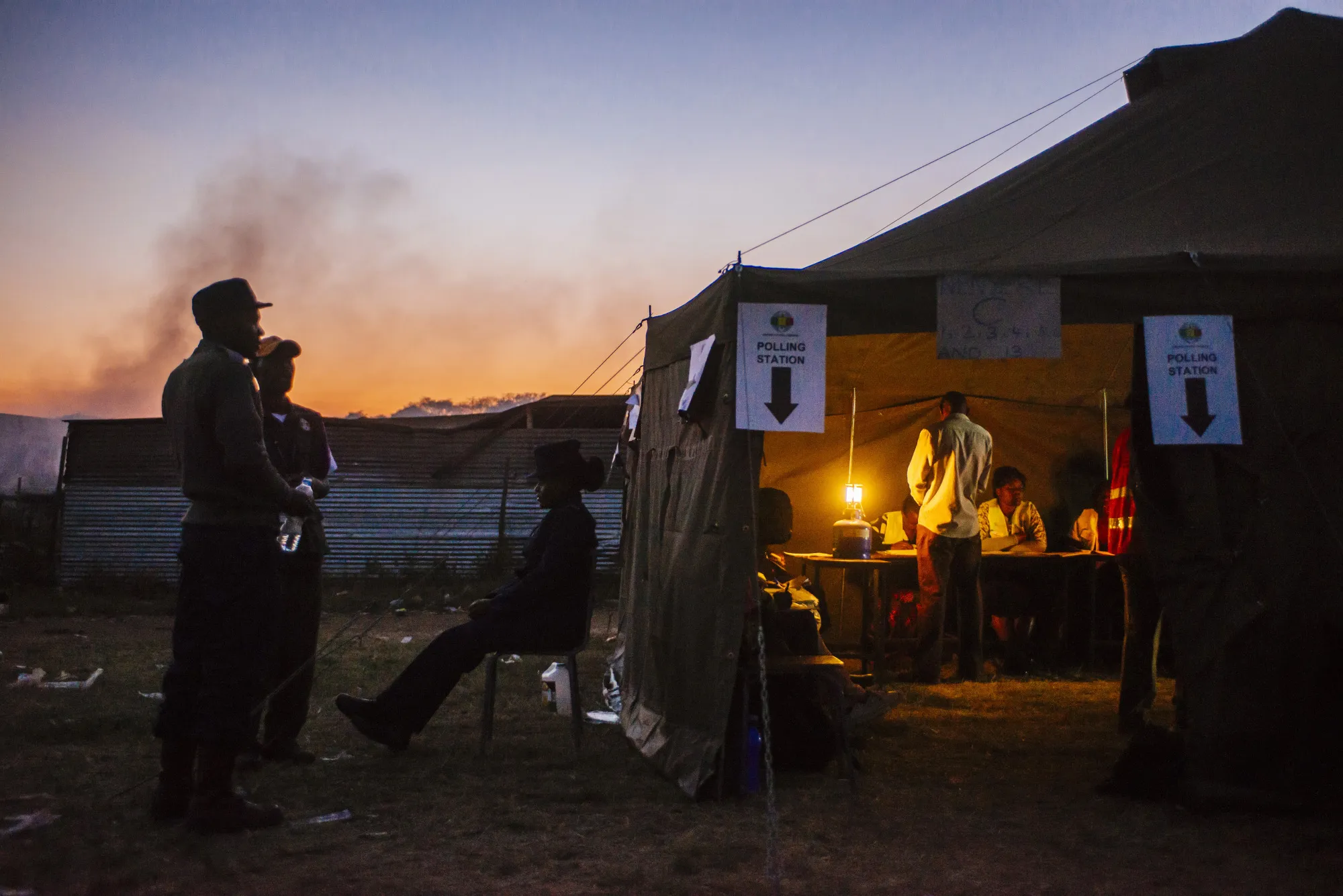 Voters wait in line to cast their ballots at a polling station in the Mbare&nbsp;township, Harare, on July 30.