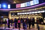 Customers wait in line to purchase concessions at a Regal Cinemas movie theater in Los Angeles, California.