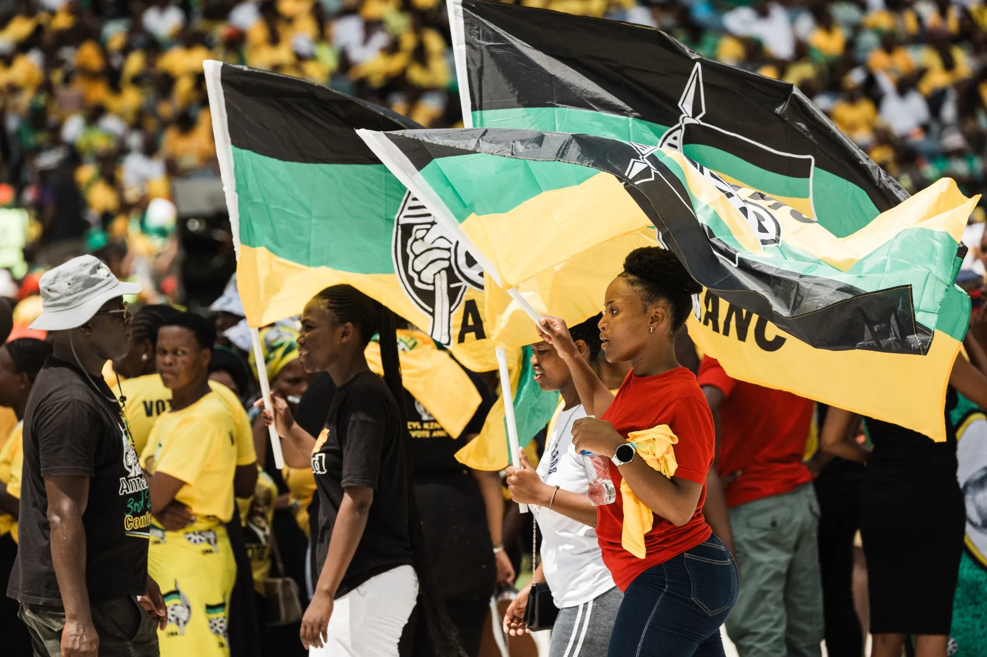 Supporters display African National Congress (ANC) flags.