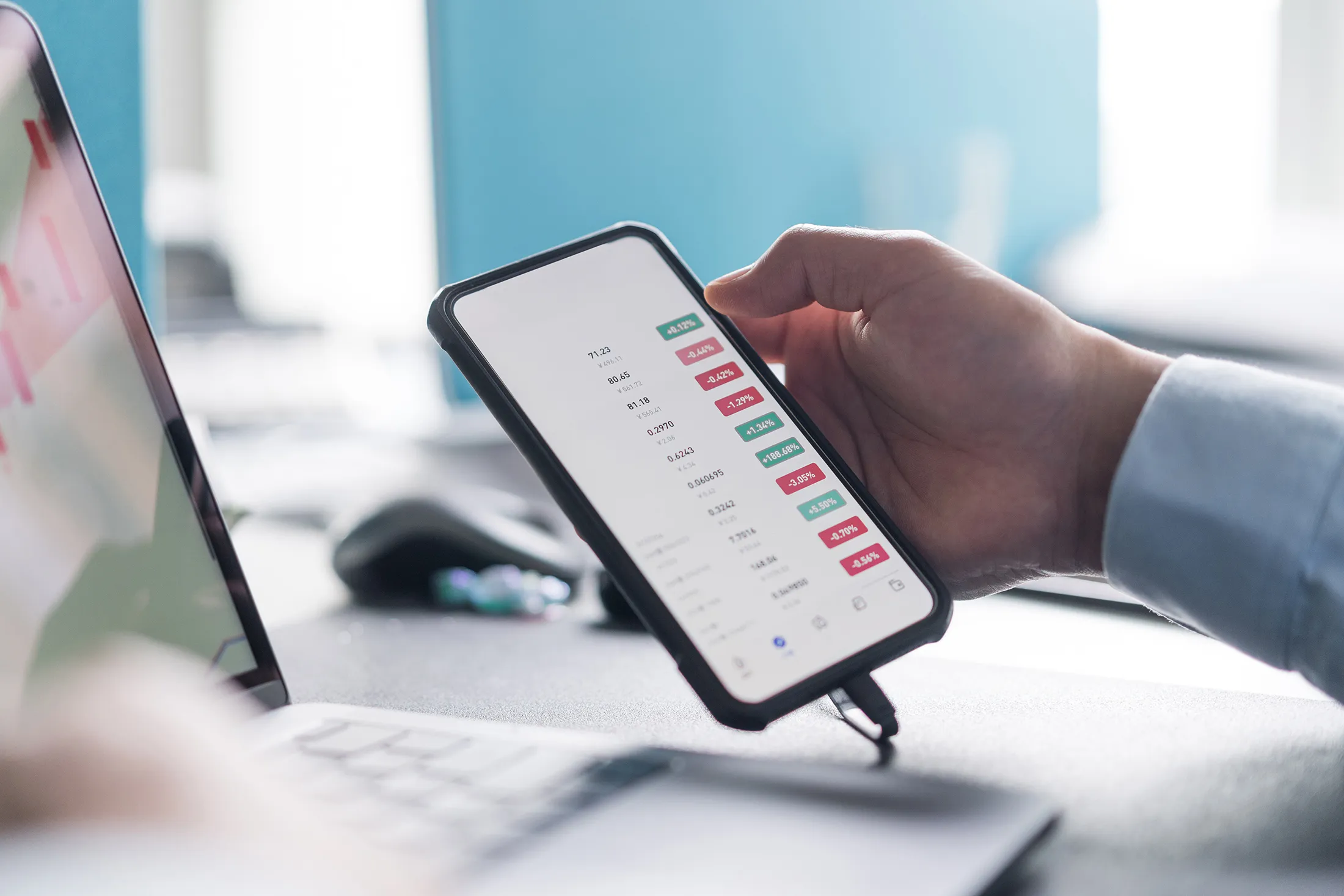 people uses laptop and mobile phone on table