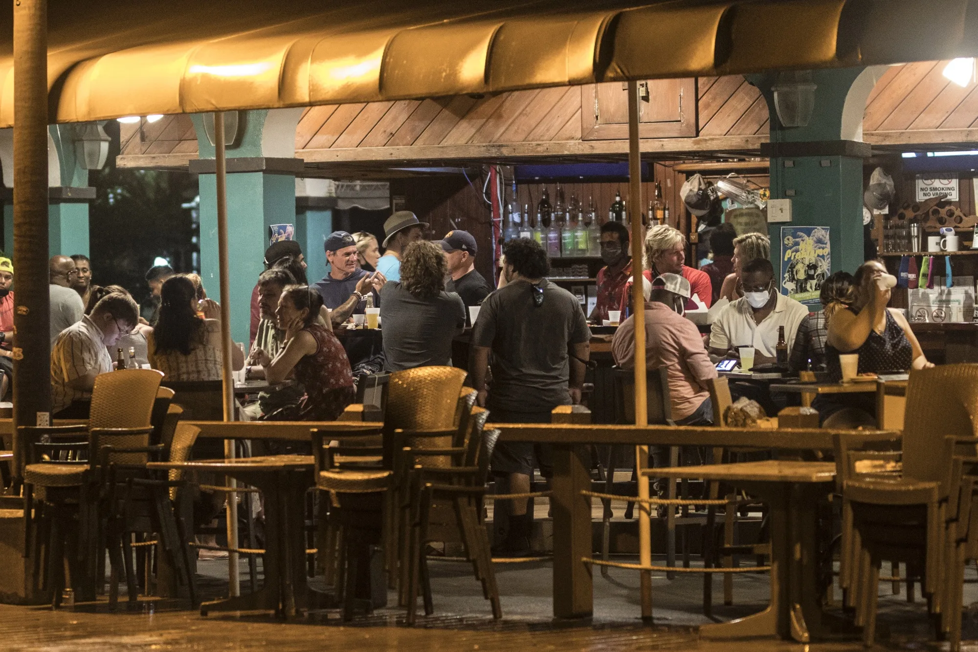 Customers sit in the outdoor dining area of a restaurant in Saint Croix, Virgin Islands, earlier this year.