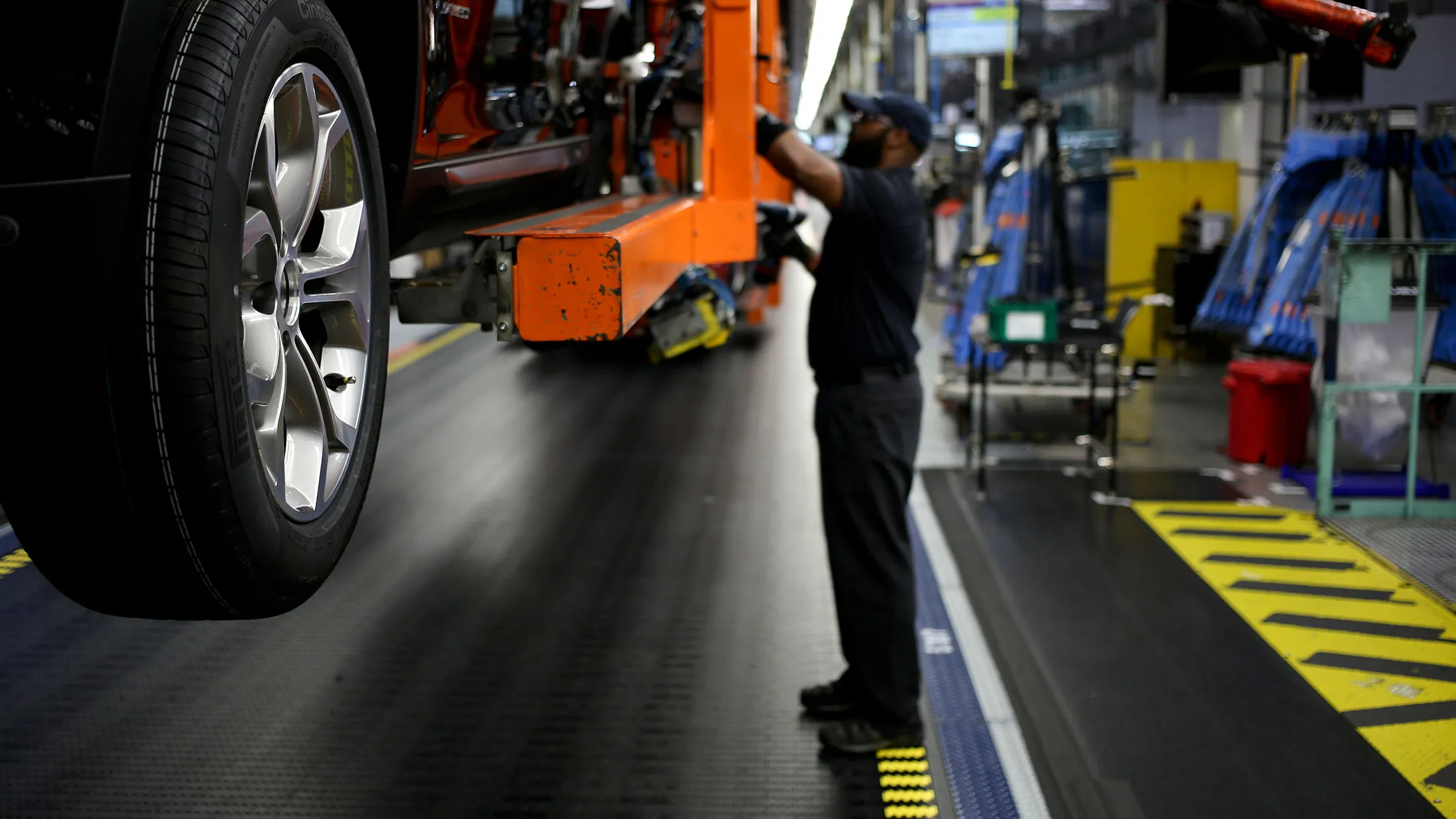 An employee attaches wheels to a Bayerische Motoren Werke AG (BMW) vehicle on the assembly line at the BMW Manufacturing Co. assembly plant in Greer, South Carolina.
