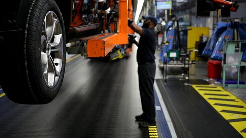 An employee attaches wheels to a Bayerische Motoren Werke AG (BMW) vehicle on the assembly line at the BMW Manufacturing Co. assembly plant in Greer, South Carolina.