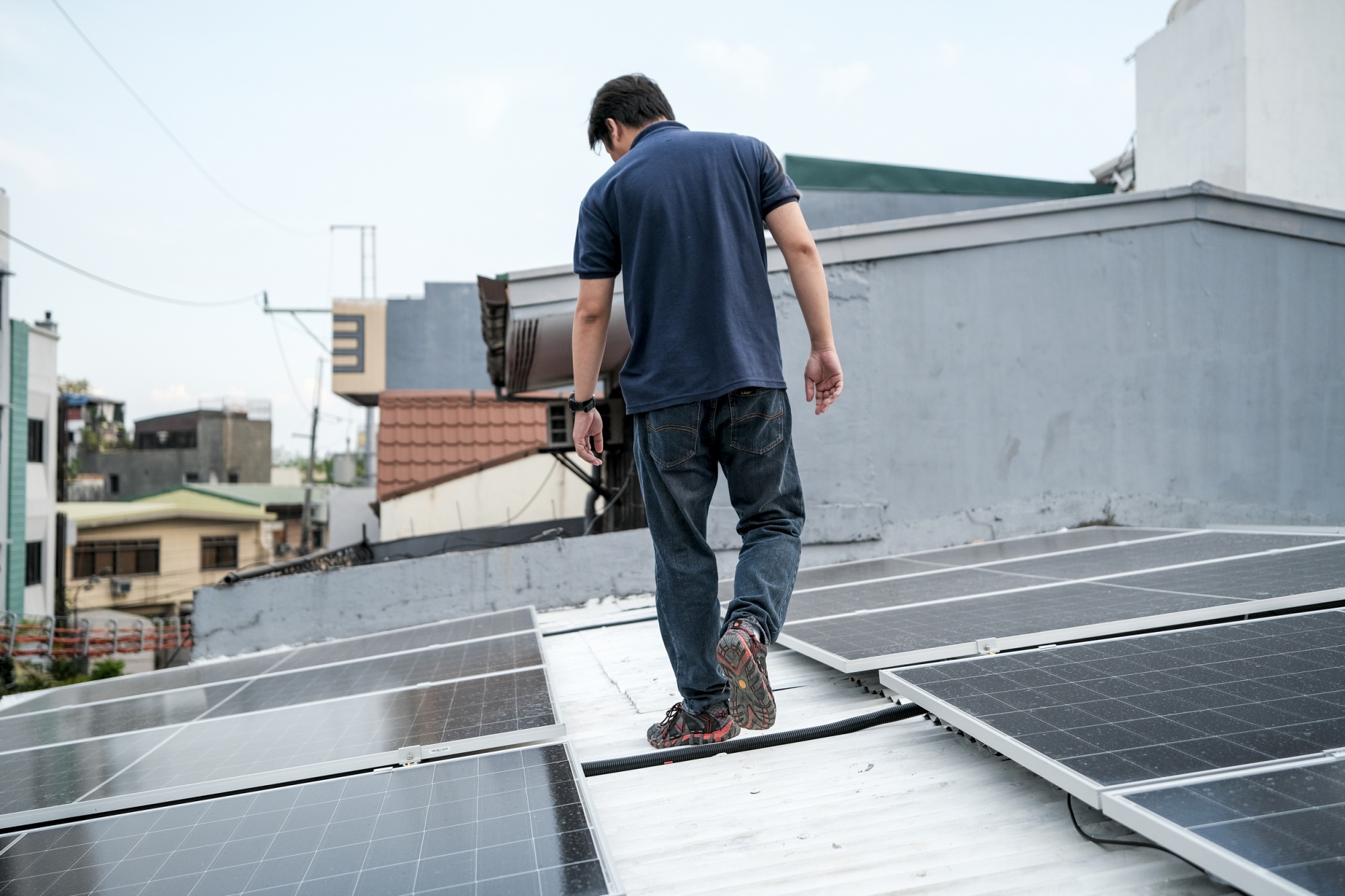 Walter Serrano, a 39-year old nurse, does a routine check of his solar installation in Manila, Philippines, May 12, 2026. Photographer: Veejay Villafranca/Bloomberg